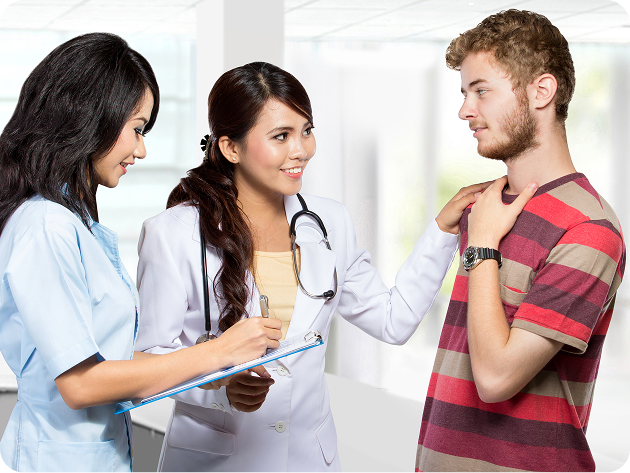 Medical professional talking with young male teen