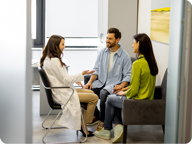 Adult couple sitting inside healthcare consultation clinic room